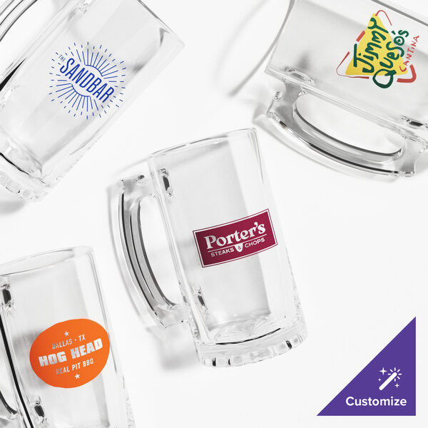 A group of Acopa customizable glass beer mugs with clear handles.