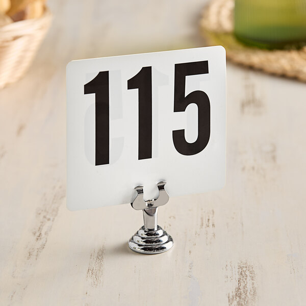 An American Metalcraft stainless steel low profile card holder with a white sign and black numbers.