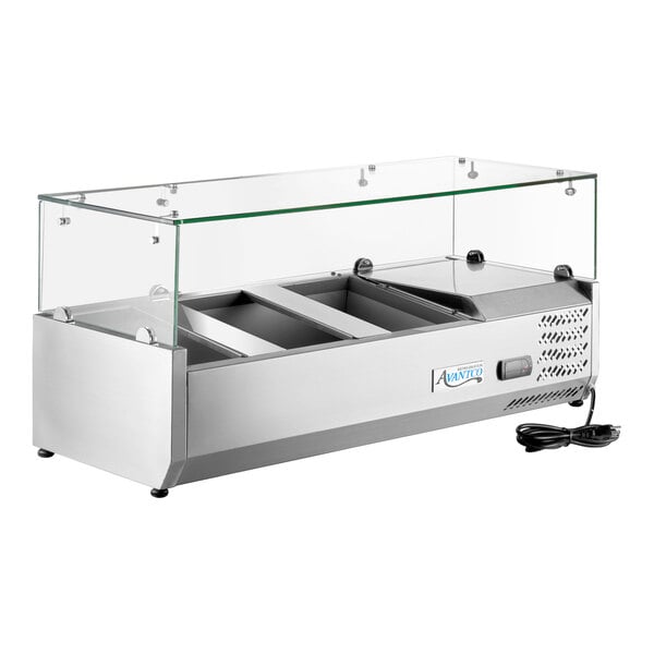 A stainless steel countertop refrigerated prep rail with a glass sneeze guard and multiple food compartments.