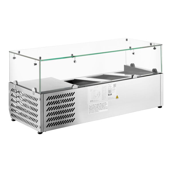 A stainless steel countertop refrigerated prep rail with a glass sneeze guard.