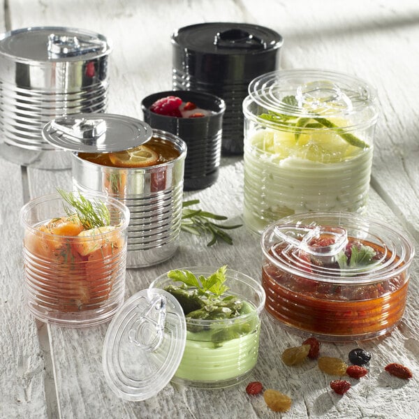 A Solia silver plastic tin can with a lid filled with a variety of different colored food.