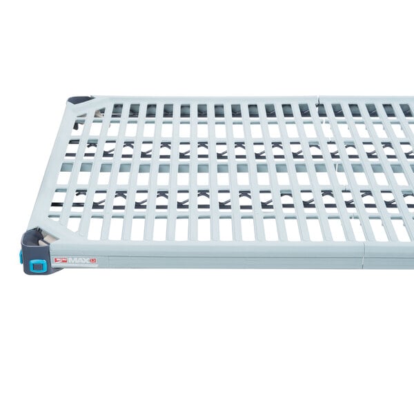 A white plastic MetroMax Q shelf with blue handles.