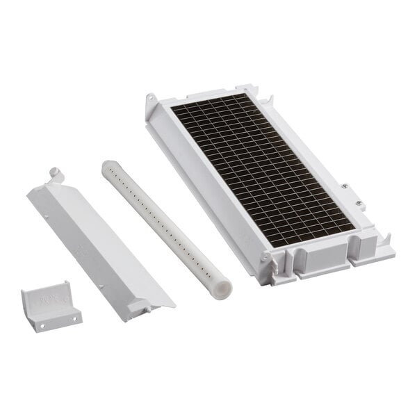 A white rectangular evaporator coil with black grids on a metal plate.