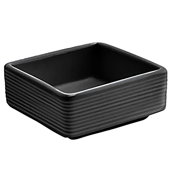 A black square porcelain ramekin with a spiral design.