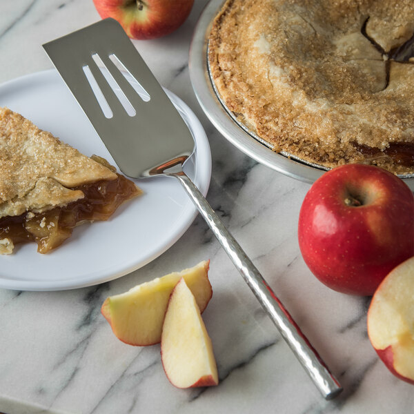 A slice of pie on a plate with a Carlisle Terra stainless steel slotted pastry server.