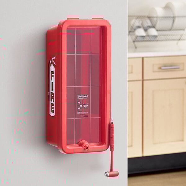 A red Cato fire extinguisher box mounted on a wall with a hammer attachment.