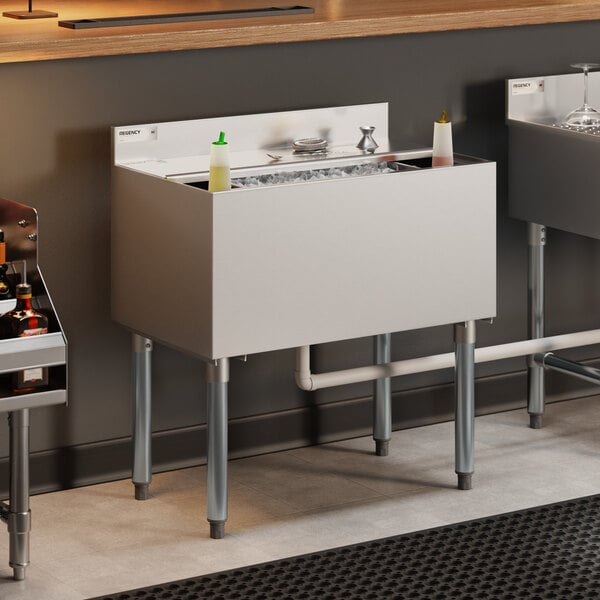 Regency 18" x 30" Stainless Steel Underbar Ice Bin with Bottle Holders and Sliding Lid - 98 lb.