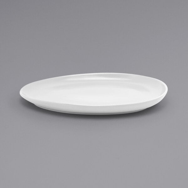 A close-up of a white Front of the House Tides oval porcelain plate.