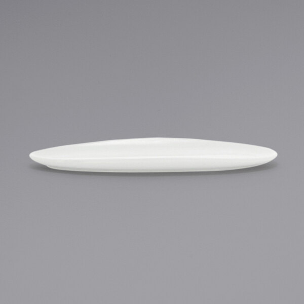 A Front of the House Tides white oval porcelain plate on a gray surface.
