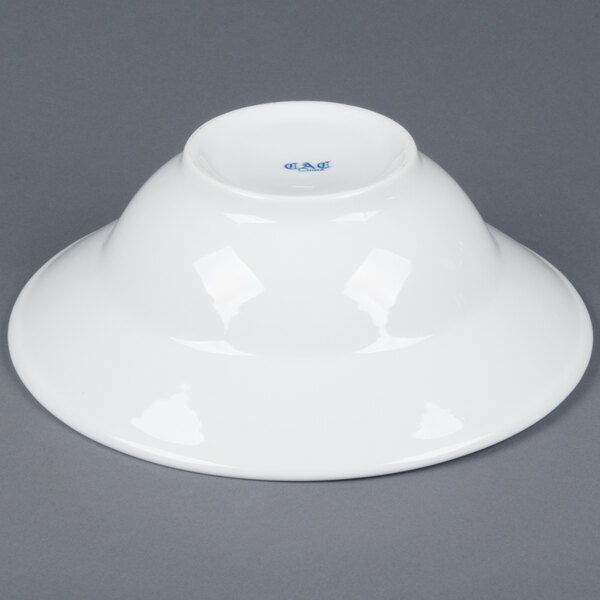 A white CAC porcelain mixing bowl with blue writing on it.