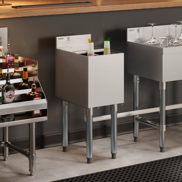 An 18-inch by 12-inch stainless steel underbar ice bin with bottle holders and a sliding lid, designed for bar use.