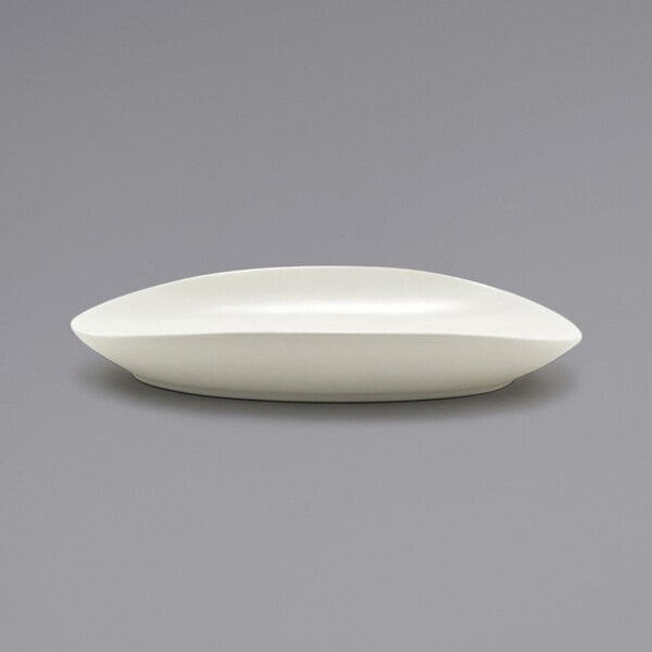 A white Front of the House Tides scallop oval porcelain plate.