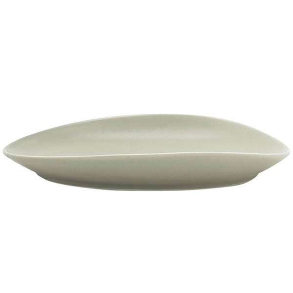 A white Front of the House Tides oval porcelain plate with a curved edge.
