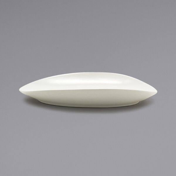 A white oval porcelain platter with a scalloped edge.
