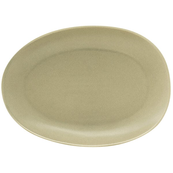 A close-up of the front of a white oval plate with a shadow.