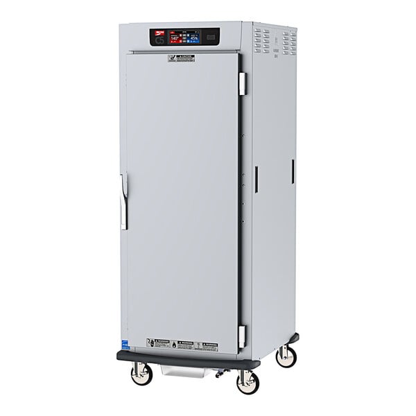A Metro C5 heated holding / proofing cabinet with a stainless steel door on wheels.