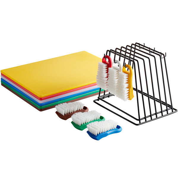 A rack with brushes and six colorful plastic cutting boards.