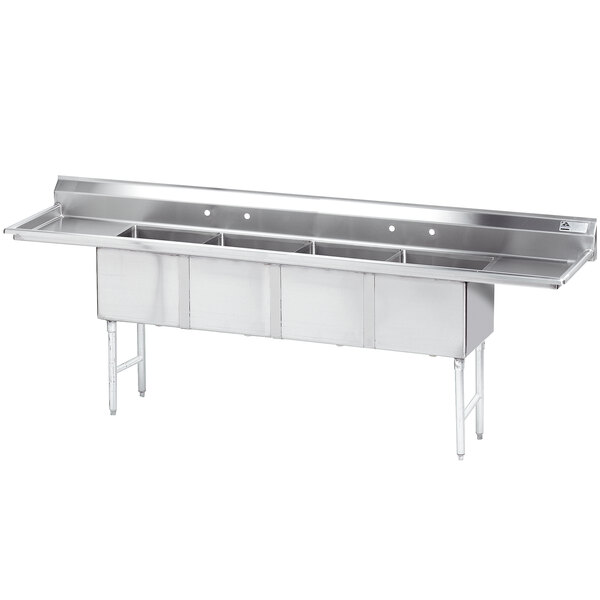 An Advance Tabco stainless steel four-compartment pot sink with two drainboards.