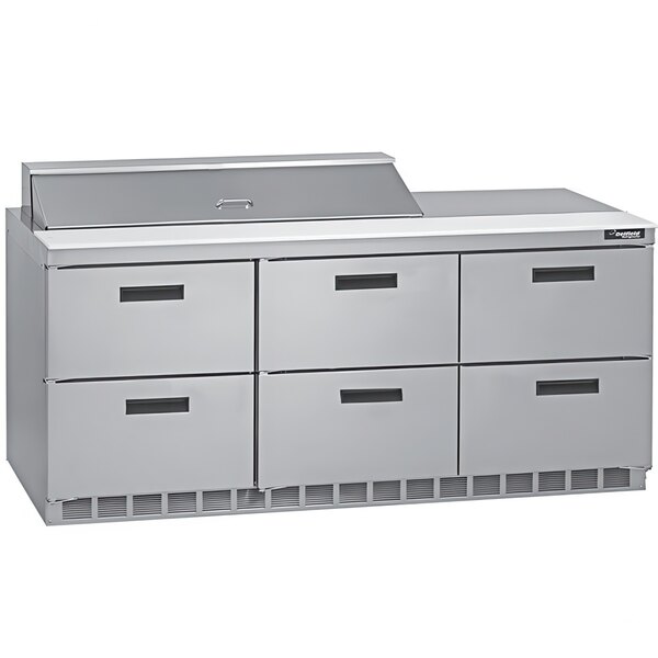 A Delfield stainless steel refrigerated sandwich prep table with six drawers on a kitchen island.