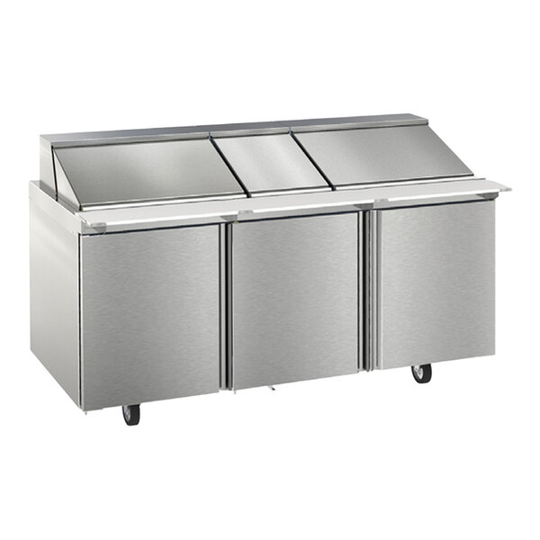 A Delfield stainless steel refrigerated sandwich prep table with three doors.