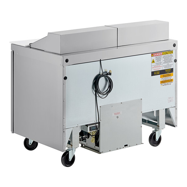 A Delfield stainless steel refrigerated sandwich prep table on wheels.