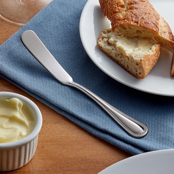 a plate with a piece of bread and butter on it
