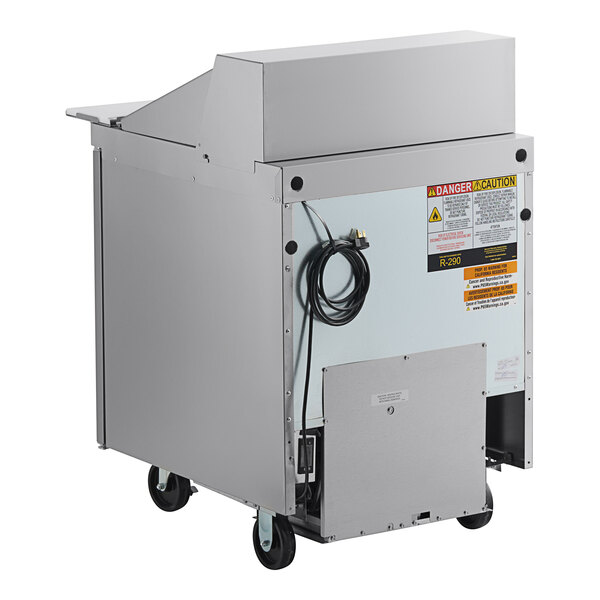 A stainless steel Delfield commercial sandwich prep table with wheels.