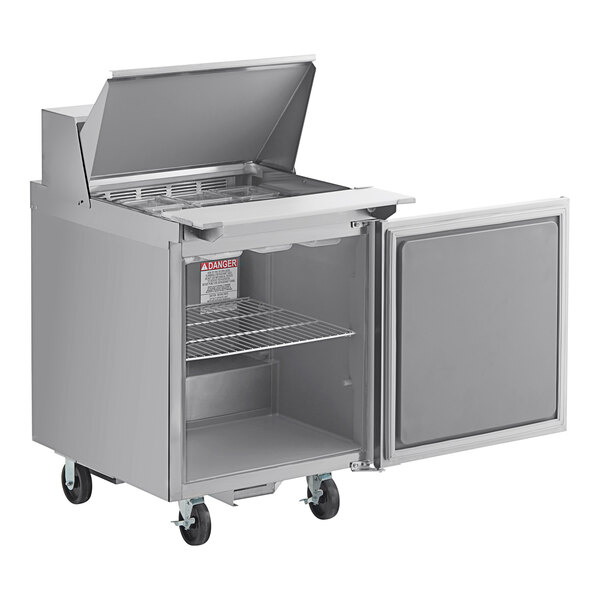 A large stainless steel Delfield refrigerator with a lid open.