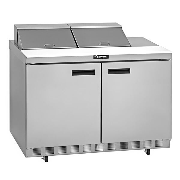 A stainless steel Delfield sandwich prep refrigerator with two doors on a counter.