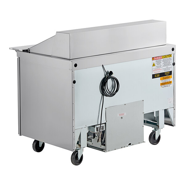 A Delfield commercial sandwich prep table with a stainless steel top and wheels.