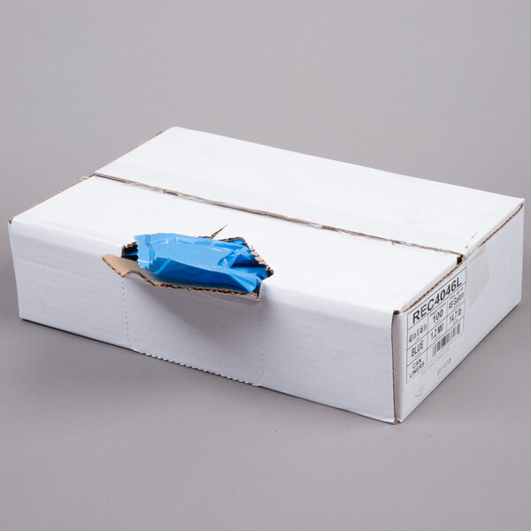 A white box with blue tape containing blue recycling bags.