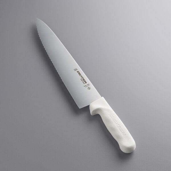 A Dexter-Russell Sani-Safe Scalloped Chef Knife with a white handle.