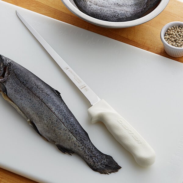 A Dexter-Russell Sani-Safe Fillet Knife cutting a fish.