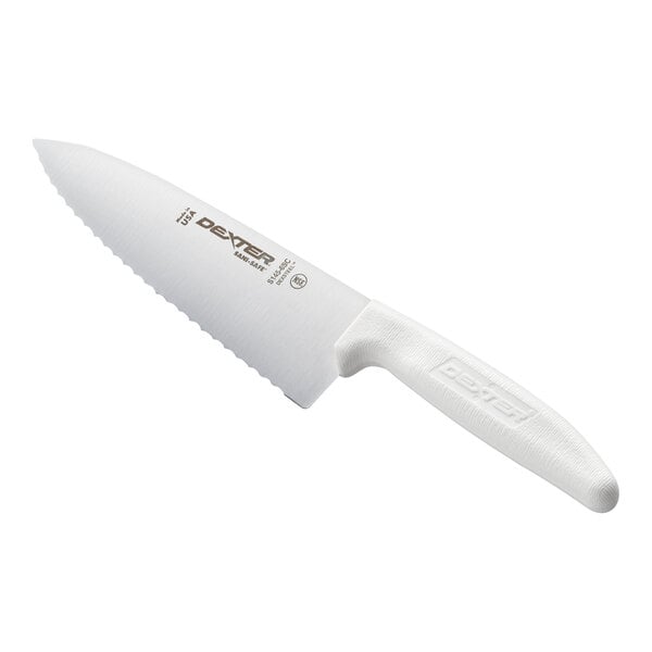 A chef knife with a scalloped blade and a textured white handle.