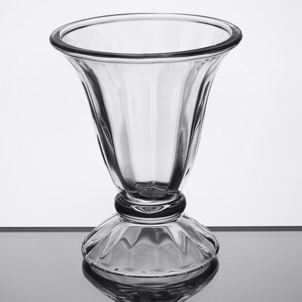 A Libbey clear tulip sundae glass on a table.