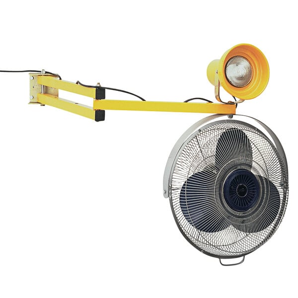 A yellow wall mounted fan with a light on it.