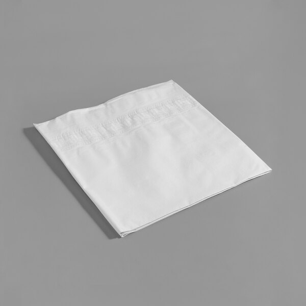 A white folded Hoffmaster Cellutex table cover on a gray surface.
