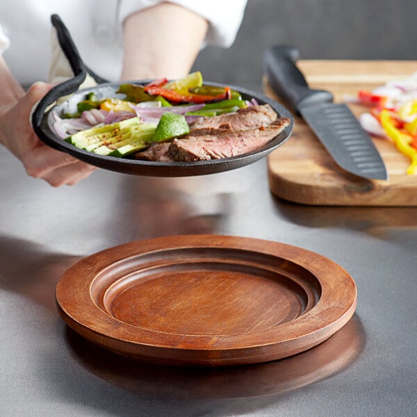 A person holding a pan with food on a Valor Rustic Chestnut underliner.