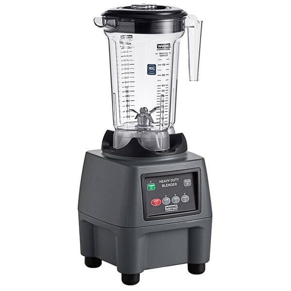 A Waring commercial food blender with a clear container.