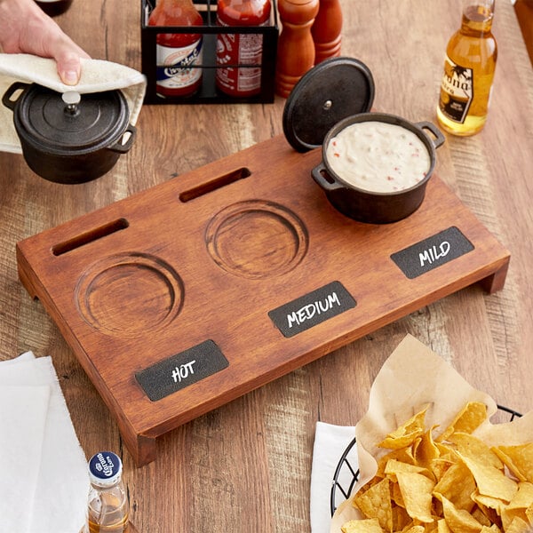 A Valor rubberwood display stand with food on it and chalkboard labels.