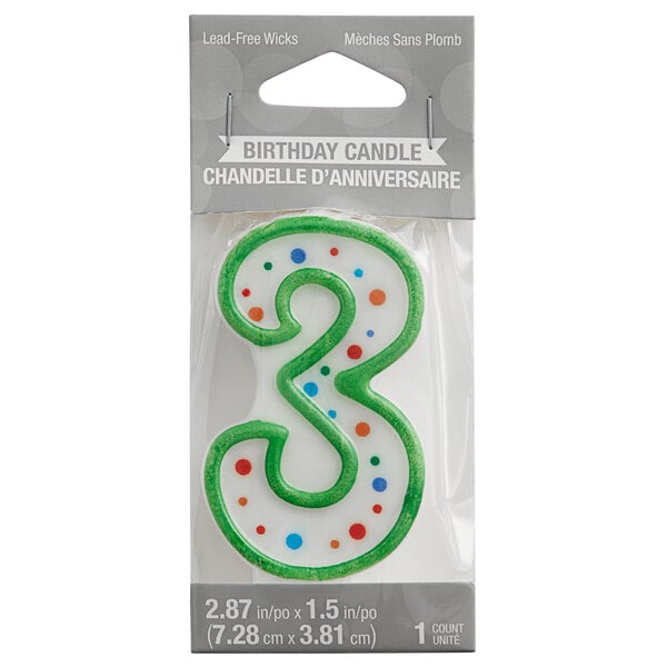 A green and white polka dot "3" candle with a green number three.