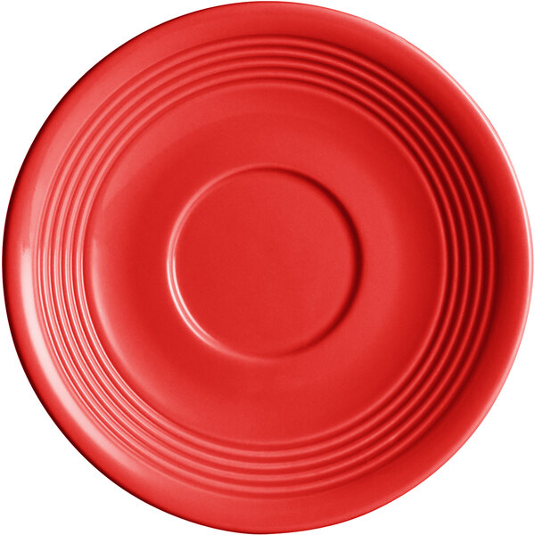 A red Acopa Capri stoneware saucer with a rim and circular object.