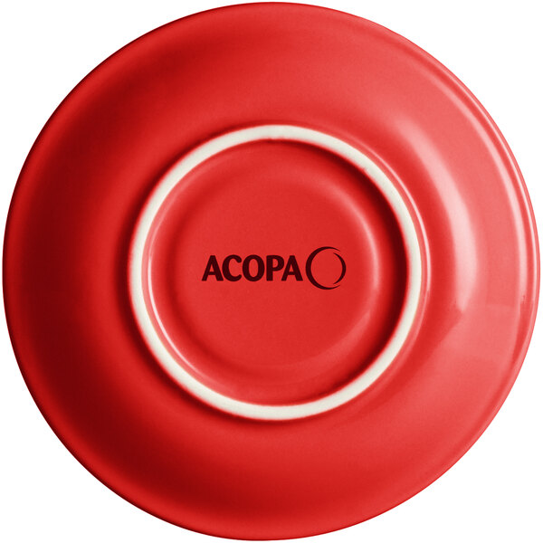 A close-up of an Acopa Capri red stoneware saucer with a white rim.