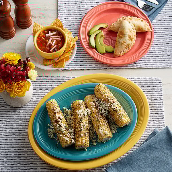 An Acopa Capri citrus yellow stoneware bouillon filled with corn on the cob.