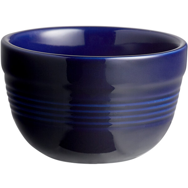 A close-up of a blue Acopa Capri stoneware bouillon bowl with lines on it.