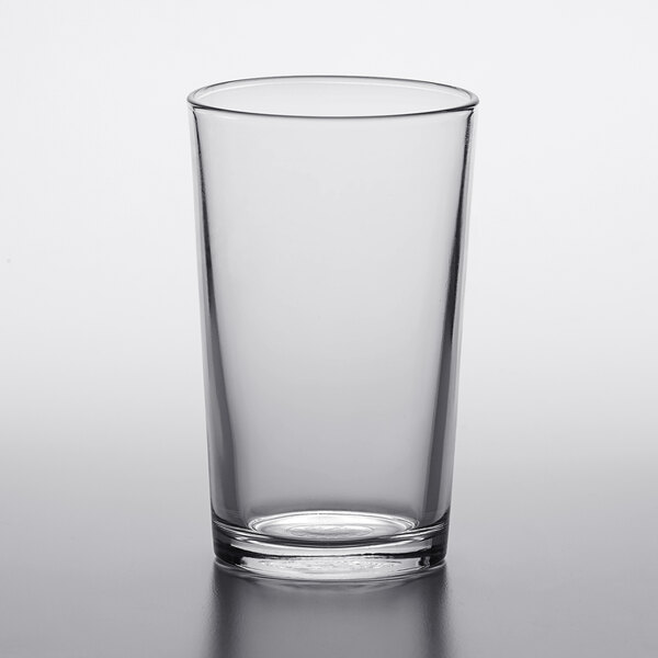 A clear Duralex glass tumbler on a white surface.