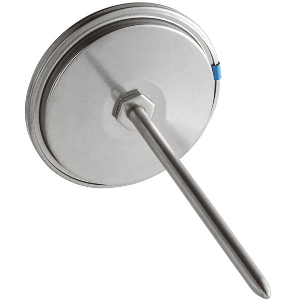 a metal round object with a long handle