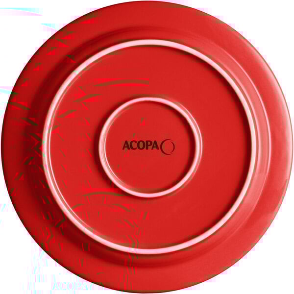 A red stoneware plate with a white circle and the word Acopa in the middle.