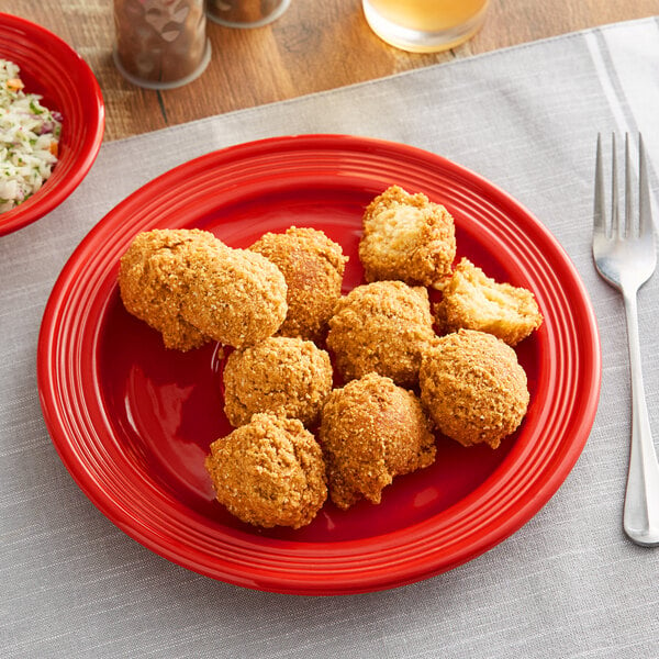 A plate of fried chicken and rice on an Acopa Capri passion fruit red stoneware plate.