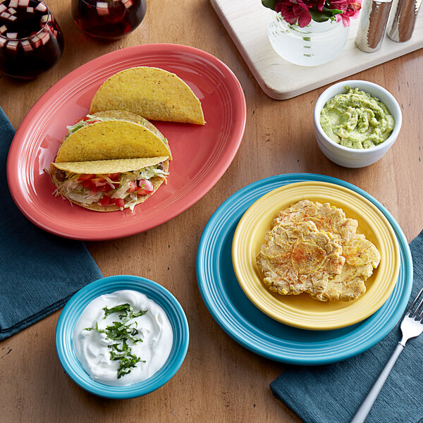 A table set with Acopa Caribbean turquoise stoneware bowls, plates, and tacos.